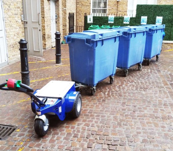 Jobmaster HD Electric Pedestrian Tug towing blue bins