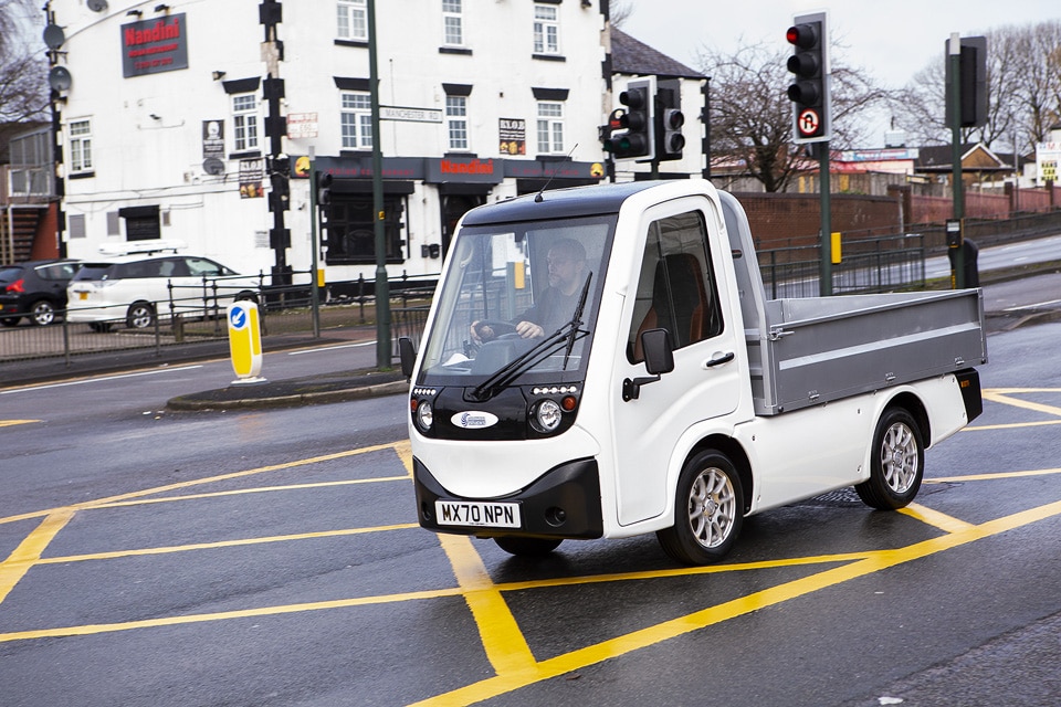 X-Cell Road Legal Electric Utility Vehicle passing through traffic lights