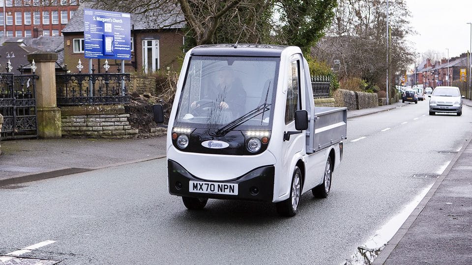 Man driving X Cell Electric Vehicle