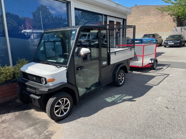 EP AMP XL with trailer parked in front of ePowerTrucks office