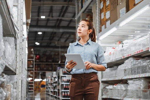 woman checking warehouse stock