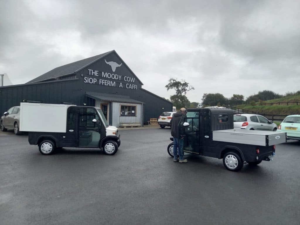 Two electric vehicles outside a farm shop