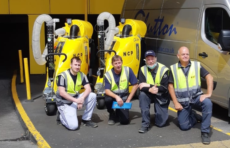 Customer Testimonials 5 Cleaning team in front of 2 Glutton electric street cleaning vacuums